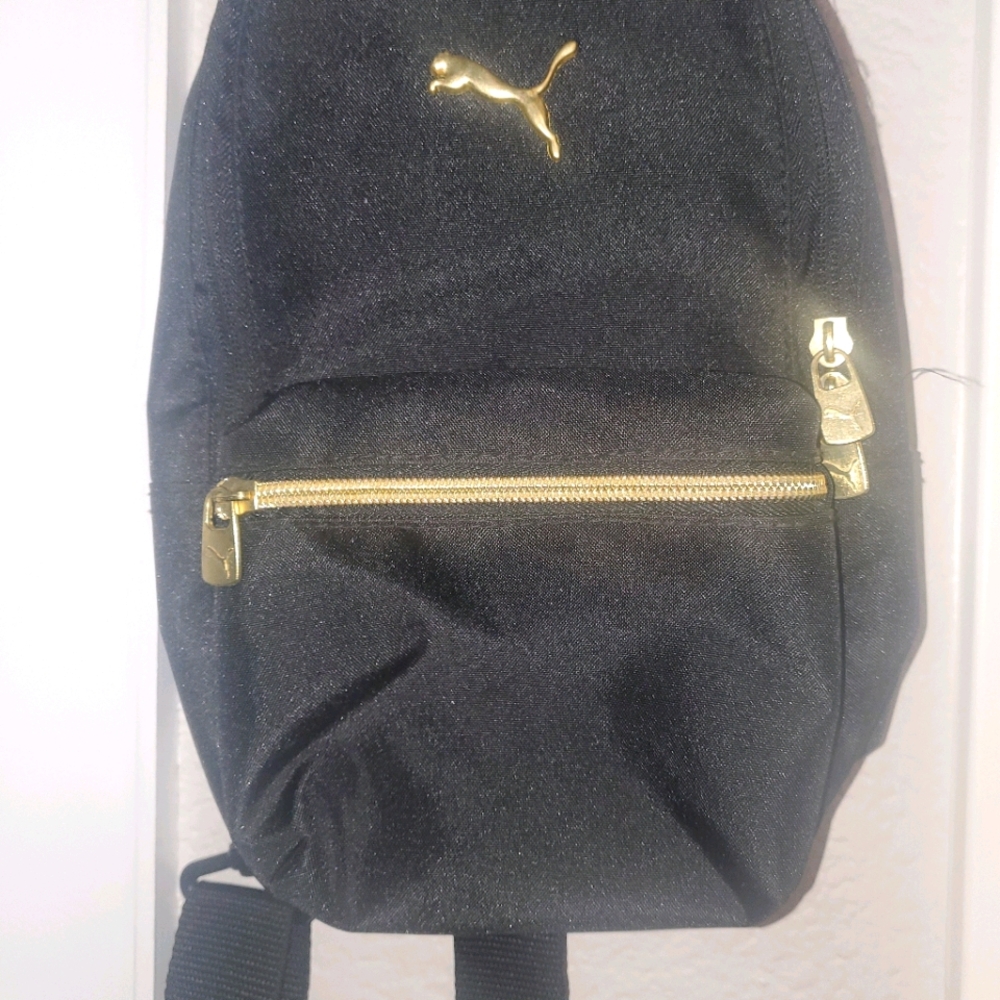 Puma cross body back pack. Gold and Black.